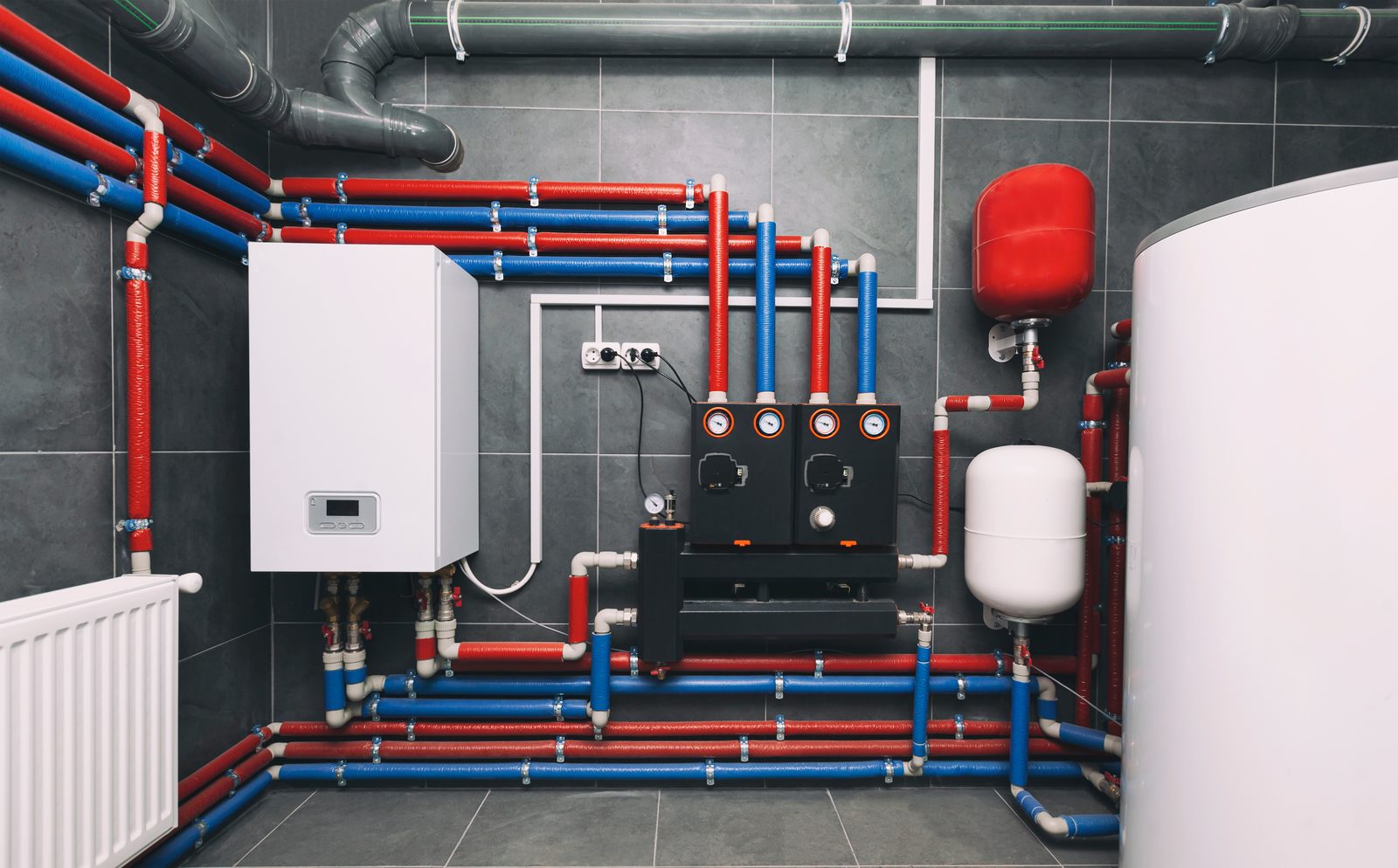 Water heater and manifold system installed with insulated hot and cold supply lines